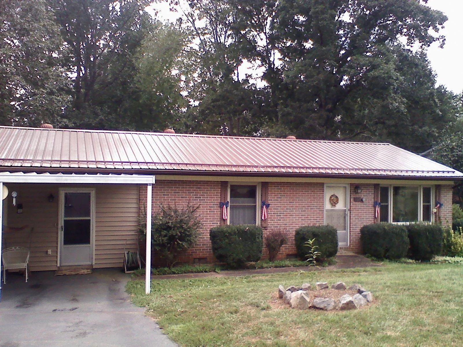Bronze metal roof and carport on a brick ranch home — Roof Repair work by our crew in Central Bridge